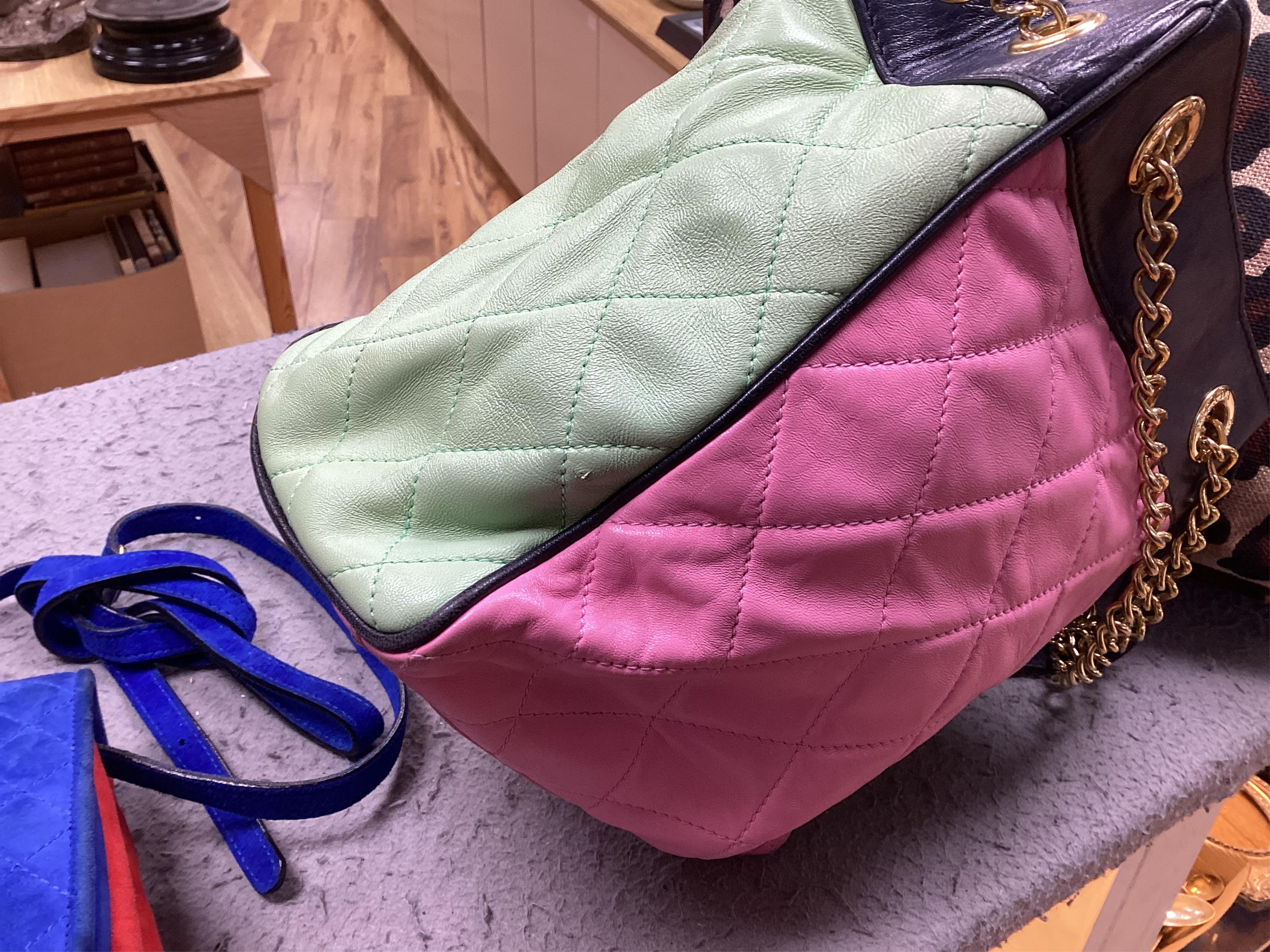 A selection of lady's handbags, including an animal print Stuart Weitzman shoulder bag with dust bag, an Escada suede royal blue and red shoulder bag, and another Escada handbag in navy blue with pink and light green qui